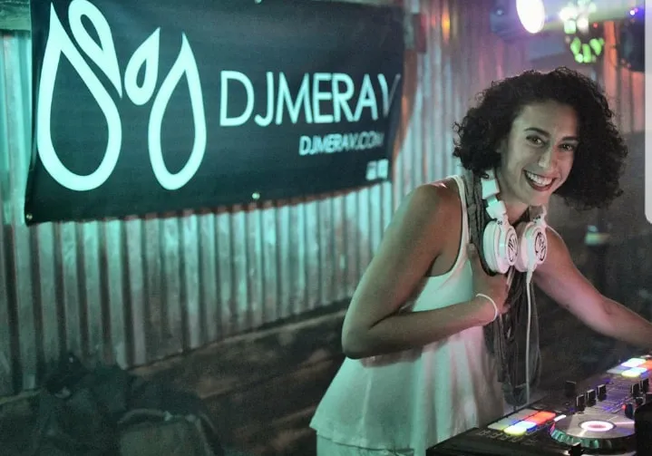 Merav in front of the DJ Merav banner
